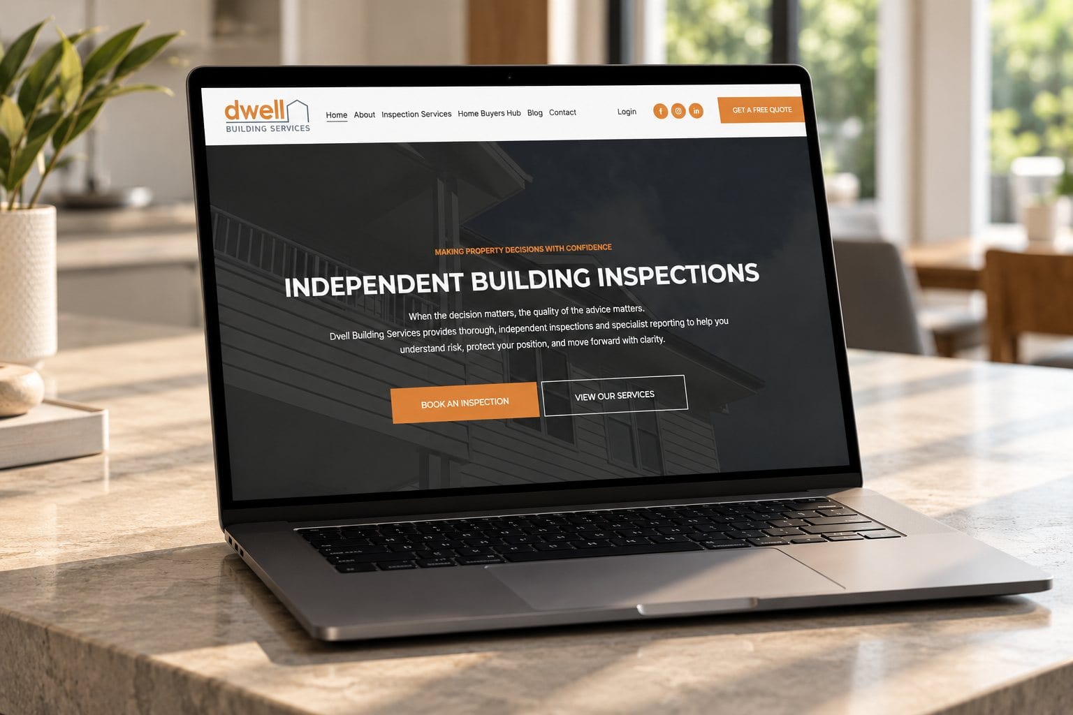 Dwell Building Services website shown on a laptop and phone, a Sheppard Creative project